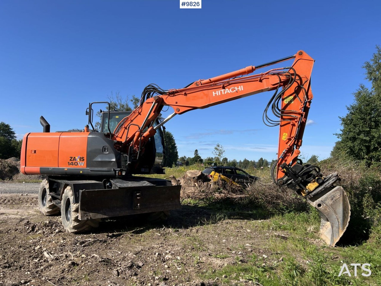 Hitachi ZX140 W-5B with rotor and planer bucket - Pelle sur pneus: photos 1 Hitachi ZX140 W-5B with rotor and planer bucket - Pelle sur pneus: photos 1
