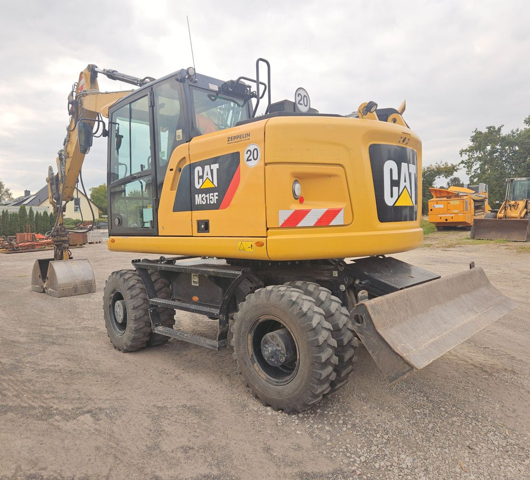 CAT M315F, orig. 2.828h - Pelle sur pneus: photos 2 CAT M315F, orig. 2.828h - Pelle sur pneus: photos 2