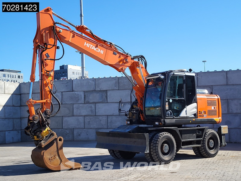 Hitachi ZX140W -5 OUTRIGGERS + BLADE - Pelle sur pneus: photos 2 Hitachi ZX140W -5 OUTRIGGERS + BLADE - Pelle sur pneus: photos 2