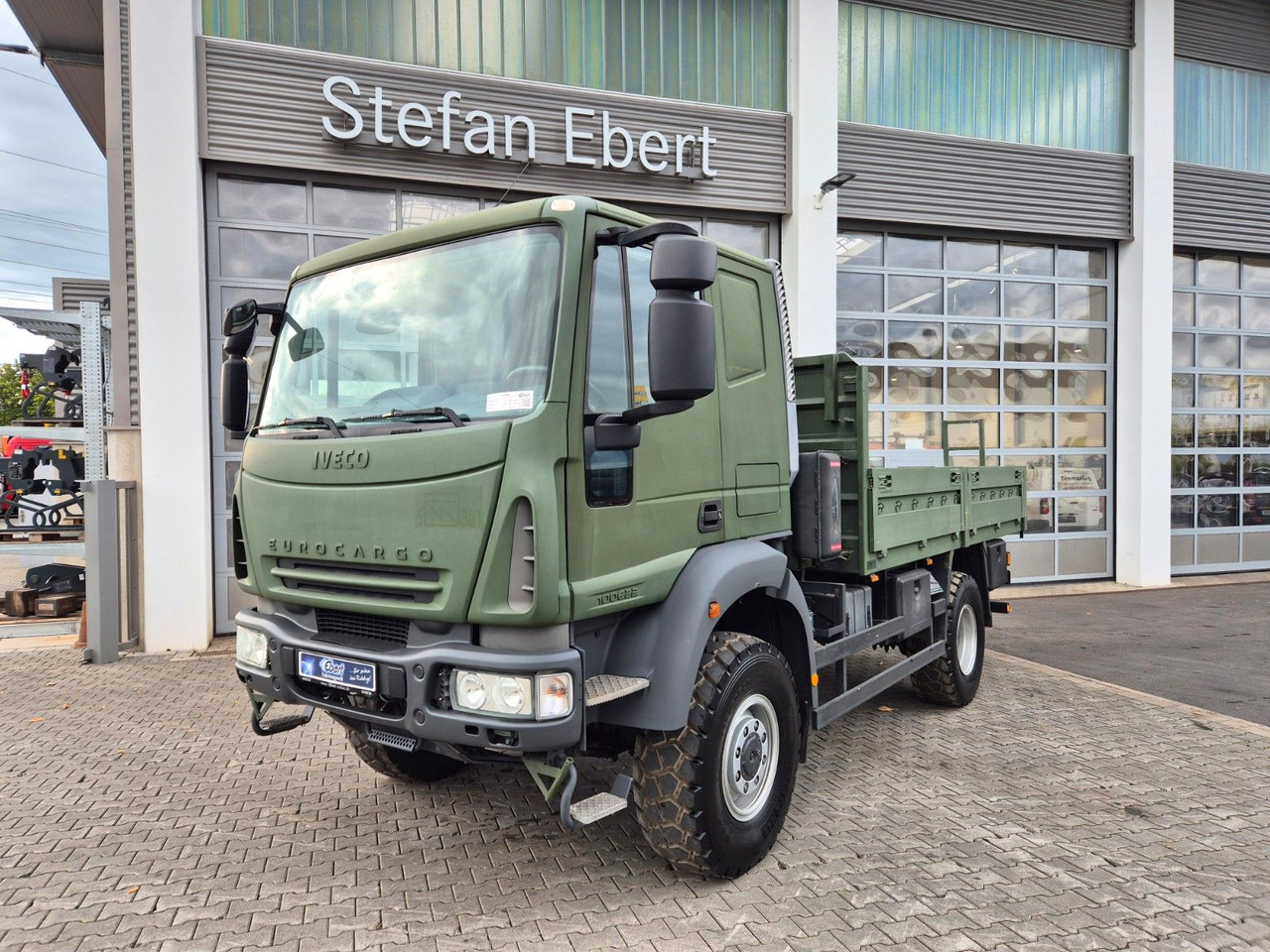 Iveco Eurocargo ML100E22WM-BW 4x4 Pritsche L-Haus Bett - Camion plateau: photos 1 Iveco Eurocargo ML100E22WM-BW 4x4 Pritsche L-Haus Bett - Camion plateau: photos 1